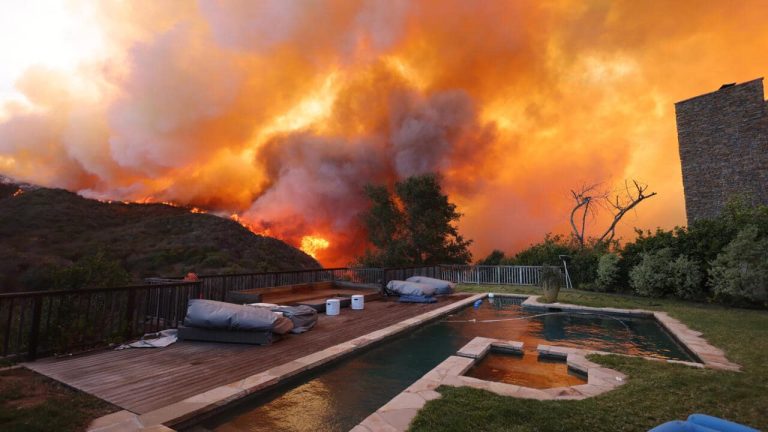 Firefighters battled into the night against the wildfire that roared through the affluent Pacific Palisades neighborhood in Southern California on Tuesday, destroying homes and forcing at least 30,000 residents to evacuate.